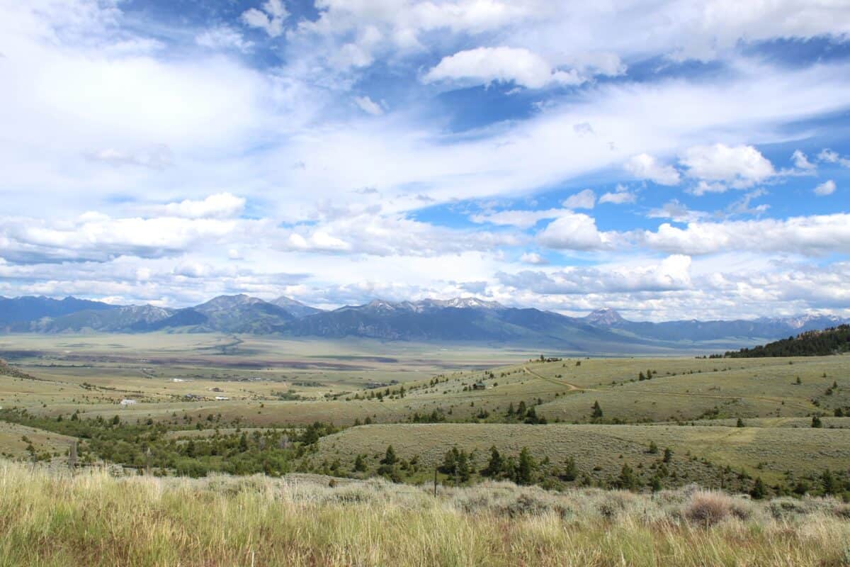 Madison Valley with vast grazing lands on both sides of the Madison River. Mountains in the background.
